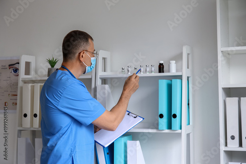 Mature male doctor in medic...