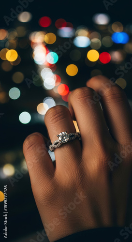Diamond engagement ring on hand with bokeh lights