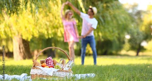 Basket with tasty food and ...