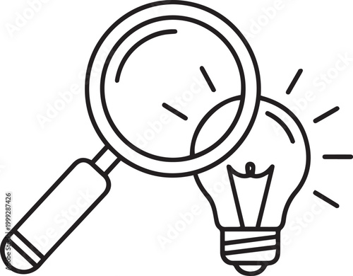 Magnifying glass over glowing light bulb