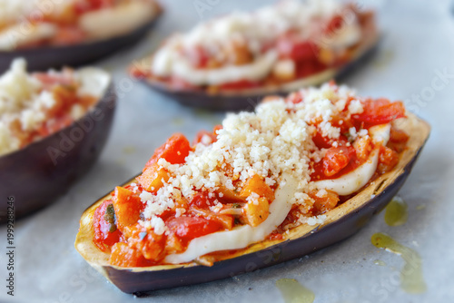 Eggpalnt boat stuffed with mozzarella, tomato and grated Parmisan cheese, neapolitan specialty.