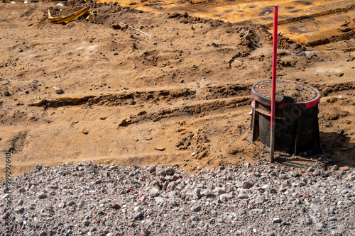 Fotografija Manhole with red stake on a construction site