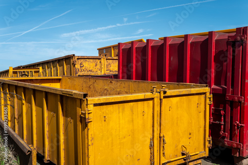 Yellow and red industrial skip bins for waste recycling