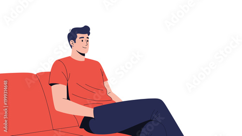 Young man wearing a red t-shirt sits comfortably on a soft sofa while relaxing at home in a bright room during his peaceful leisure time.
