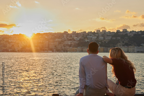 People looking at the Bay of Naples at sunset in Naples, Italy