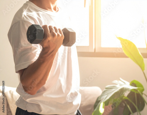 Man lifting dumbbell exercising indoors