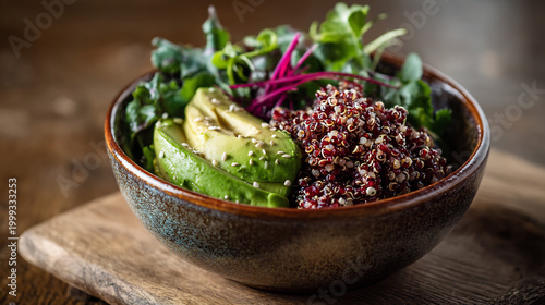 Healthy Vegan Quinoa Bowl with Sliced Avocado, Mixed Greens, and Sesame Seeds on a Rustic Wooden Board