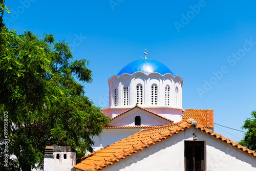 Perdiki village on Ikaria island, Greece by Saint Matrona Greek Orthodox church cross with dome at longevity blue zone small mountain town