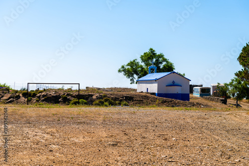 Soccer football dirt dry field gate at Perdiki mountain village on Ikaria island, Greece rural countryside small town at longevity blue zone