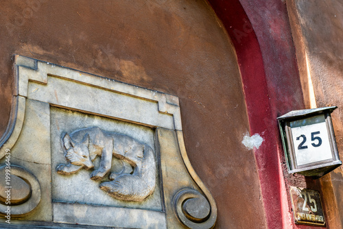 Warsaw, Poland old town market square by historic street number town architecture apartment building entrance with fox engraving decoration