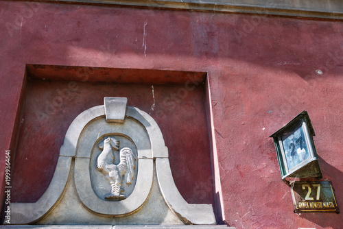 Warsaw, Poland old town market square by historic street number town architecture apartment building entrance with rooster engraving decoration