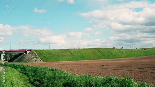 Passing cars next to fields 