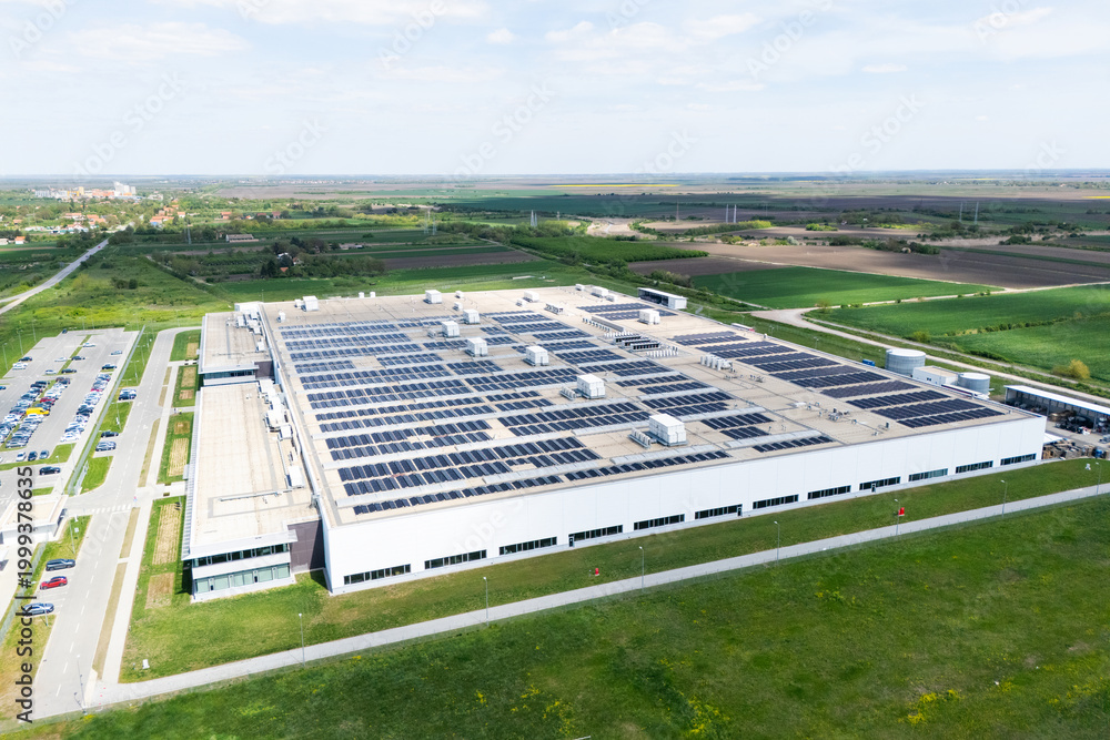 Fototapeta premium Aerial view of a modern logistics center with solar panels on the roof