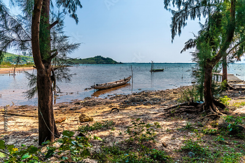 Quadro em tela A view past a sampan from the shady shoreline beside an oyster farm on the Lap A