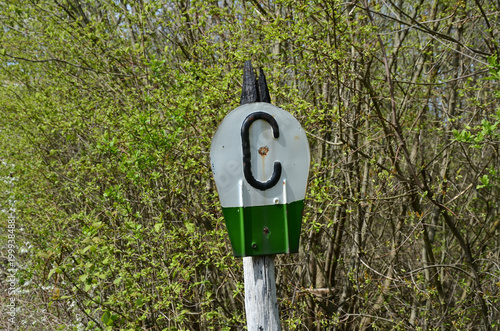 A railway signal sign with the Cyrillic letter 'S' (standing for 'Svistok' - Whistle) used in post-Soviet countries (Russia, Ukraine, Belarus, etc.).