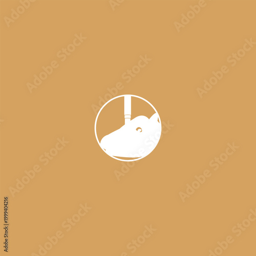 A cow tranquilizer being operated on a cow's head to ensure optimal operation. The cow's head badge logo is seen from the side and the cow tranquilizer