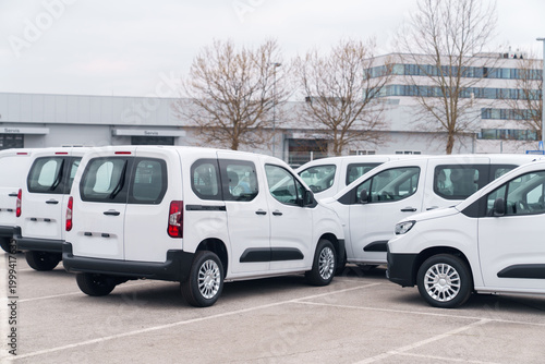 Quadro em tela White delivery vans are parked in rows