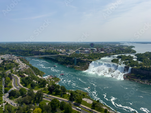 The American Falls and Bridal Veil Falls, the U.S. Customs and Border Protection – Rainbow Bridge Port of Entry, and the Prospect Point Observation Tower in Niagara Falls, Ontario, Canada.