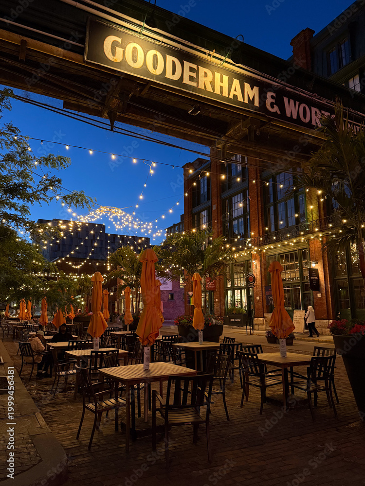 Fototapeta premium Toronto, Ontario, Canada, June 14, 2025: Gooderham and Worts, aka Gooderham and Worts Limited, was a Canadian distiller of alcoholic beverages. Gooderham and Worts Distillery sign at night.