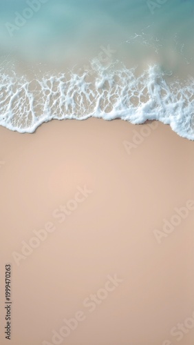 Turquoise ocean waves gently washing onto a pristine sandy beach, seen from a top aerial view, creating a tranquil natural backdrop for relaxation and summer holidays
