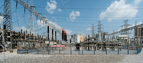Canvas Print Power Station Infrastructure with High Voltage Lines and Equipment Under Blue Sk