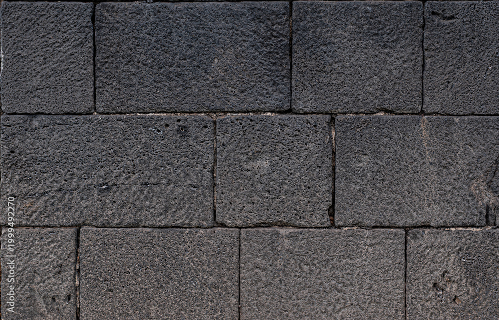 Fototapeta premium Volcanic stone wall texture of 1600s castle for design backgrounds