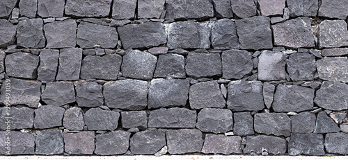 Foto Panoramic texture of natural volcanic stone wall from Tenerife Island, Spain