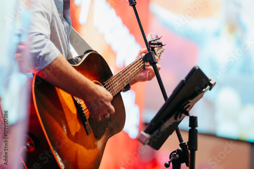 Guitarist playing an acoustic guitar, worship guitar player	