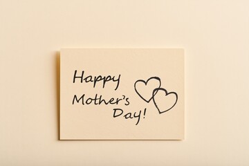 Mother's day card featuring handwritten script and hearts on beige