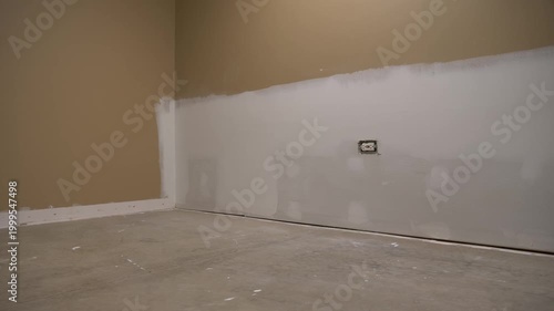 Drywall repair and patching from sump pump failure, An empty basement room with concrete floor