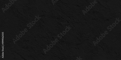 Dark black slate stone texture background, Matte charcoal rock surface for minimalist professional graphic design layout. A dark grunge texture with a rough black paper surface, weathered backdrop