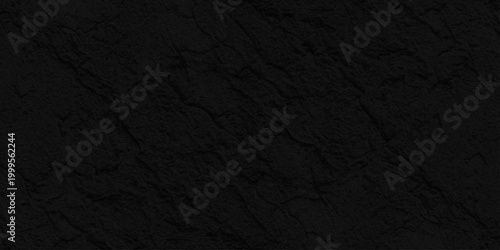 Dark black slate stone texture background, Matte charcoal rock surface for minimalist professional graphic design layout. A dark grunge texture with a rough black paper surface, weathered backdrop