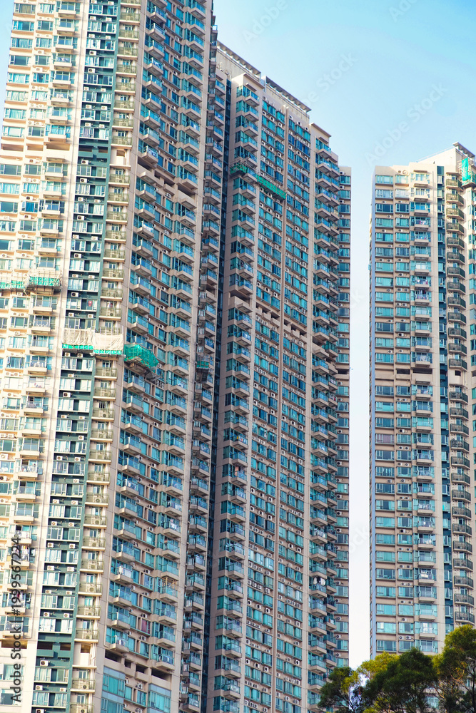 Fototapeta premium A dense cluster of high-rise residential buildings in Hong Kong, showcasing the city’s iconic urban density.