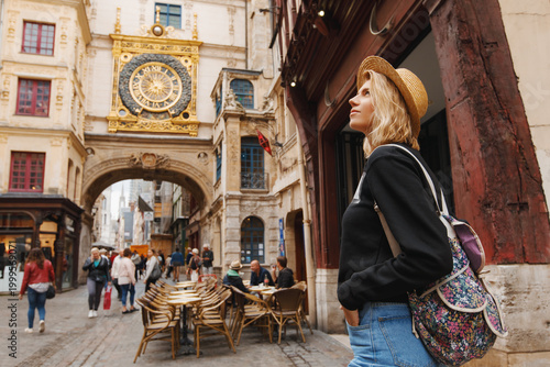 Traveler girl in Rouen city. Tourist woman posing near Gros-Horloge (Great-Clock) in Rouen, Normandy, France
