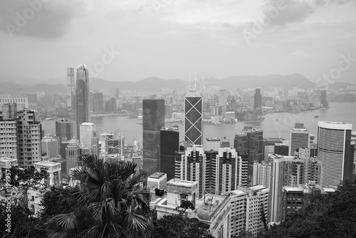 Photography A timeless black-and-white panorama of Hong Kong’s skyline viewed from above, featuring iconic skyscrapers overlooking Victoria Harbour