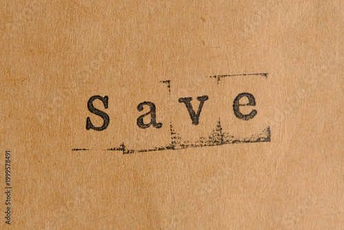 Save word in lowercase stamps on vintage paper, financial concept.