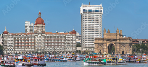 Panoramic view of Taj Mahal Palace Hotel and Gateway of India with boats from Arabian Sea, Mumbai, India.