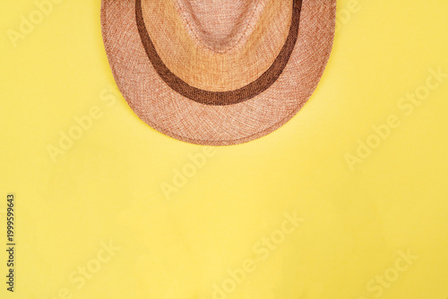 Minimalist summer vacation background with straw hat and copy space.
