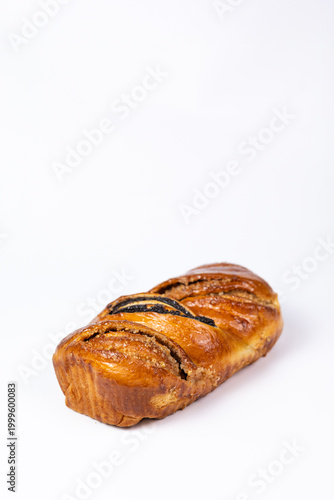Close-up of a freshly baked poppy seed roll with a golden crust.