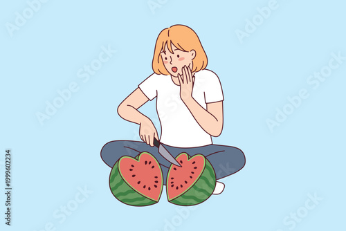 A surprised young woman sitting cross-legged while cutting a watermelon that reveals a perfect heart shape inside. Represents love for healthy eating and summer freshness.