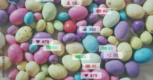 Covering dense cluster of pastel speckled candy eggs on light wood tabletop, showing social badges