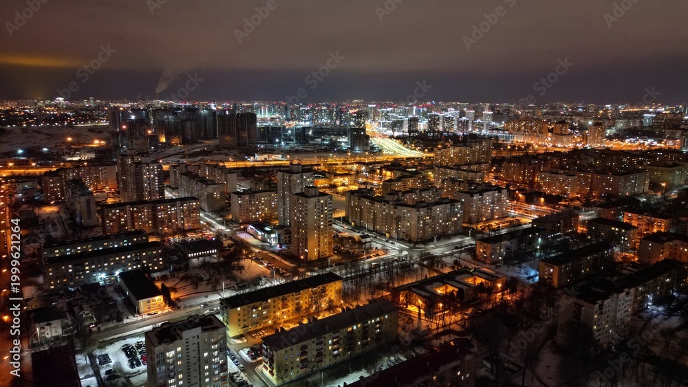 Naklejka premium Night Cityscape with Illuminated Residential District