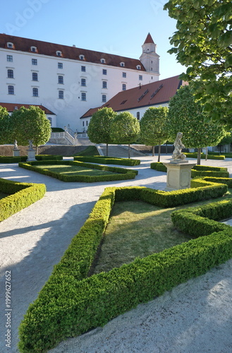 Beautiful Baroque Garden and Historic Bratislava Castle under Sunny Blue Sky in Slovakia, European Landmark Travel and Luxury Architecture Background, Manicured Boxwood Hedges and Cultural Heritage
