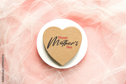 Happy Mother's Day. Top view of heart shaped gift box with the text Happy Mother's Day and round blank