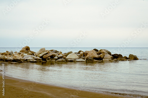 Tableau sur toile Tranquil Zapalo Beach with rock breakwater and sandy shore in Limassol, Cyprus