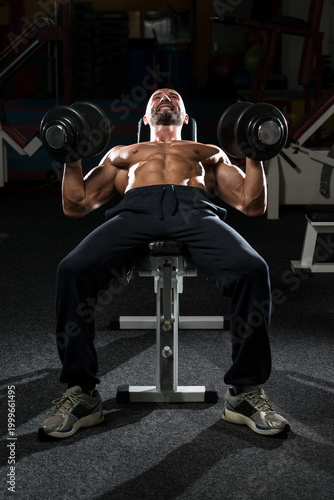 Obraz na plátně Mature Man Doing Dumbbell Incline Bench Press Workout