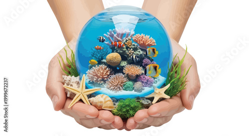 Two gentle hands holding a crystal glass globe filled with colorful tropical fish and coral