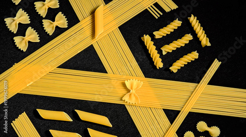 pasta types arranged geometrically on a black background