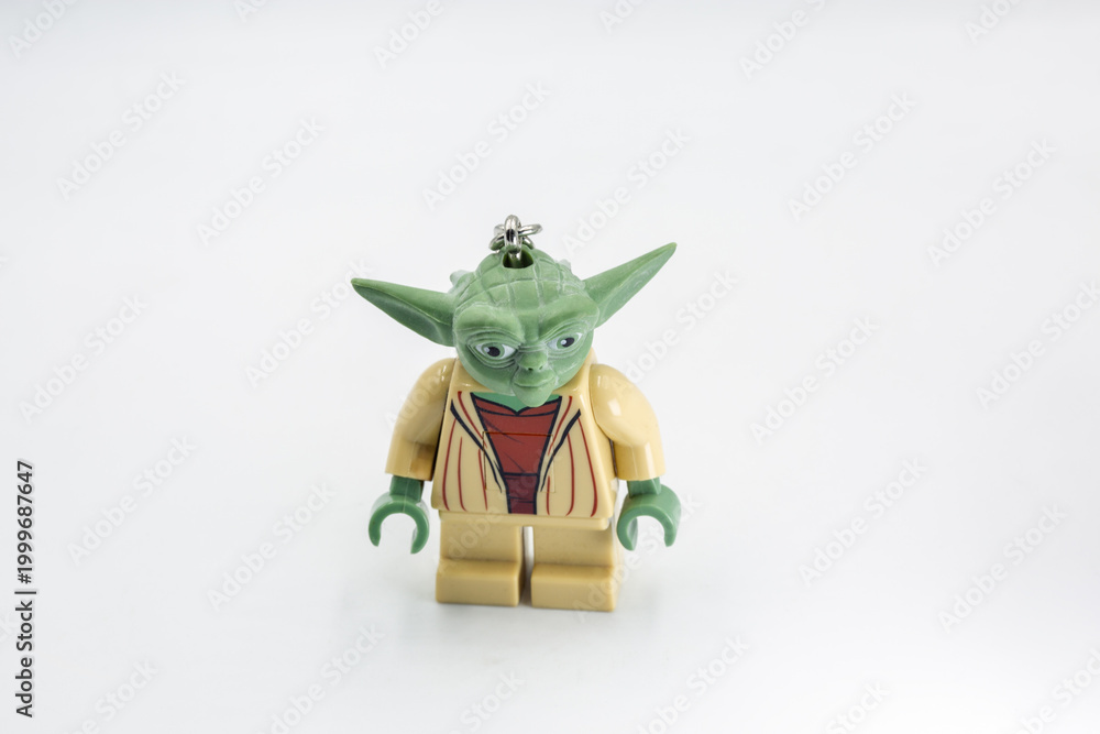 Fototapeta premium Yoda toy figure from Star Wars film closeup on white.