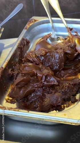 Buffet fillings for pancakes chocolate and grated cheese in metal trays closeup food station